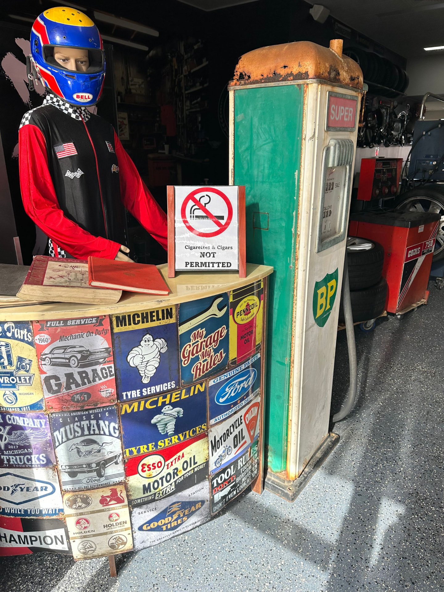 Vintage BP petrol pump and racing mannequin at the tin sign counter